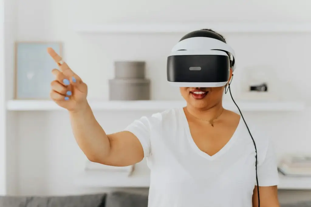 Woman using a VR headset for augmented reality interaction, gesturing while immersed in virtual environment.